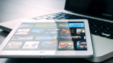Tablet displaying streaming services on a laptop, illustrating digital entertainment setup.