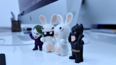 Close-up of various cartoon figurines on a modern desk setting, perfect for creativity-themed projects.