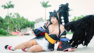 Cosplayer dressed as Nyotengu character from Dead or Alive, posing outdoors.