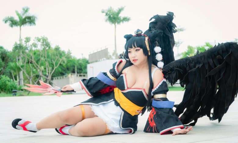 Cosplayer dressed as Nyotengu character from Dead or Alive, posing outdoors.