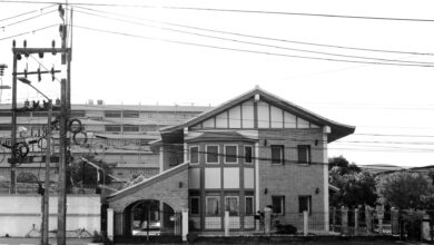 Black and white photo of a brick house with electric cables in Hat Yai, Thailand.