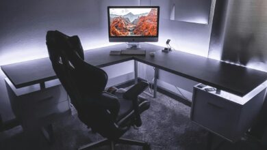 Sleek office desk setup featuring a gaming chair and widescreen monitor, ideal for productivity and gaming.