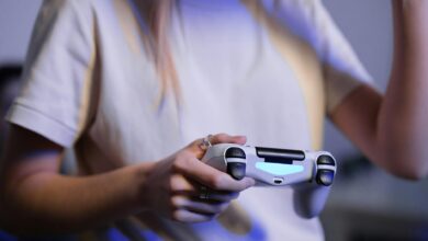 Person playing video games with game controller in a relaxed setting.