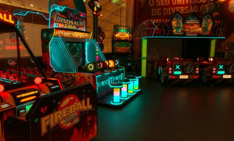 Colorful neon-lit arcade with various game machines including Fireball and Dinosaur Era.
