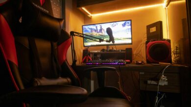 A dimly lit room showcasing an advanced gaming desktop setup with modern equipment.