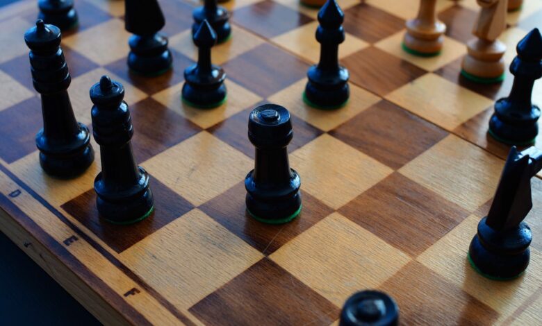 Chessboard with black and white pieces showcasing strategic positioning.