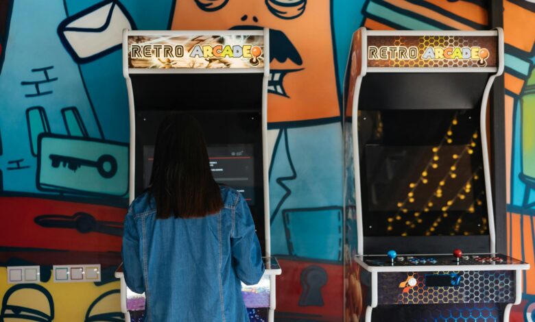 Woman engages in retro arcade gaming in a vibrant, graffiti-themed environment.