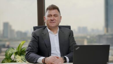 Confident middle-aged businessman in an elegant office with city view.