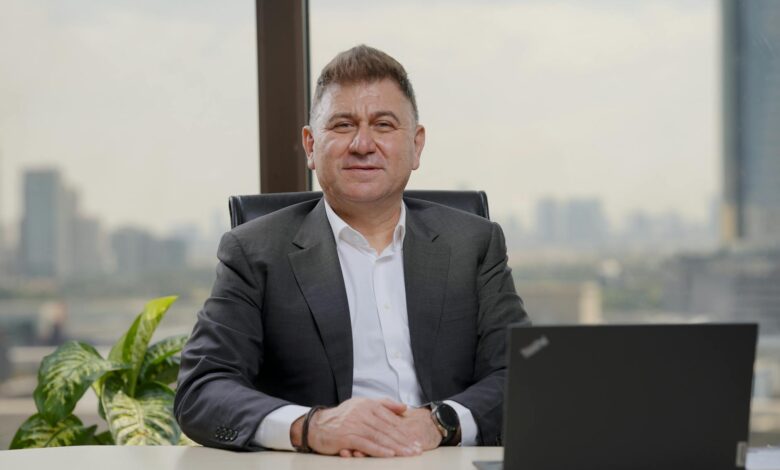 Confident middle-aged businessman in an elegant office with city view.