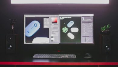A modern desktop setup featuring dual monitors, keyboard, and mouse, ideal for graphic design.
