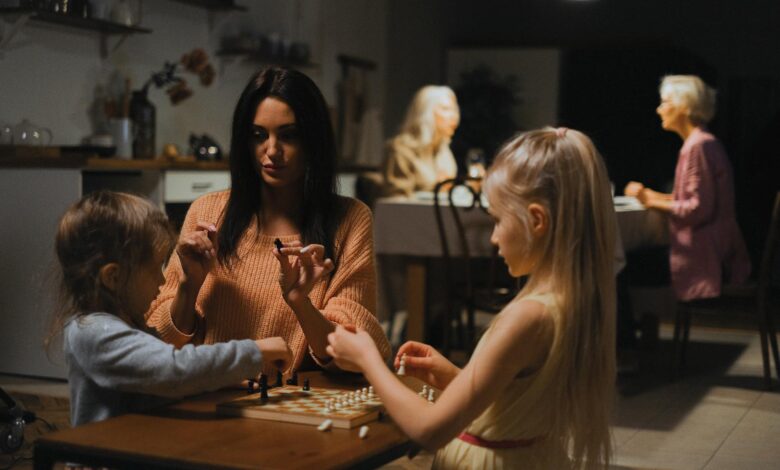 A family enjoys quality time playing chess together, fostering bonding and strategic thinking.