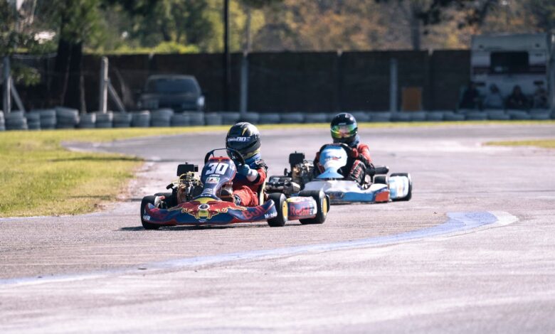 Competitive go-kart racing action captured on an outdoor circuit.
