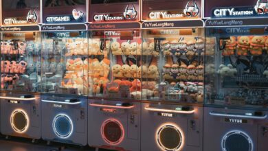 Vibrant claw machines filled with plush toys in an illuminated arcade environment.