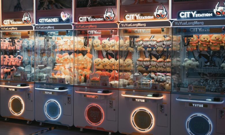 Vibrant claw machines filled with plush toys in an illuminated arcade environment.