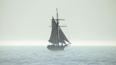 A tranquil silhouette of a sailing ship on a calm sea horizon, evoking peace and adventure.