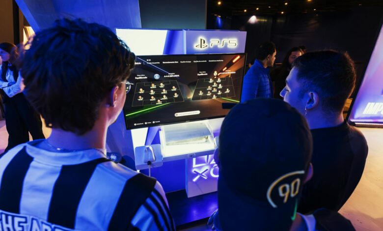 Group of gamers engaged in a PS5 event, choosing teams on a football game selection screen.
