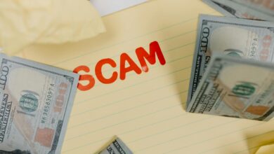 Conceptual image of financial scam with US dollars on yellow paper and word 'scam' visible.