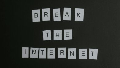 Conceptual flat lay of 'Break the Internet' message with white letters on a black background.