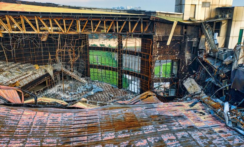 Drone shot of a fire-damaged building in Banten, Indonesia showing twisted metal and rubble.