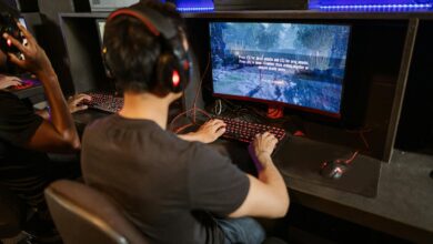 Two gamers immersed in a video game with high-tech equipment and vibrant gaming setup.