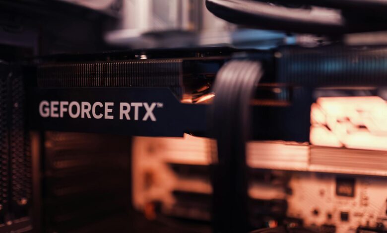 Detailed view of a GeForce RTX graphics card installed in a computer setup, highlighting modern technology.