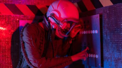 Female astronaut interacts with a control panel in a futuristic spaceship setting.