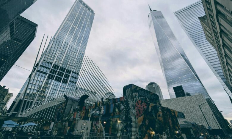 Skyscrapers and urban art converge in Lower Manhattan featuring One World Trade Center.
