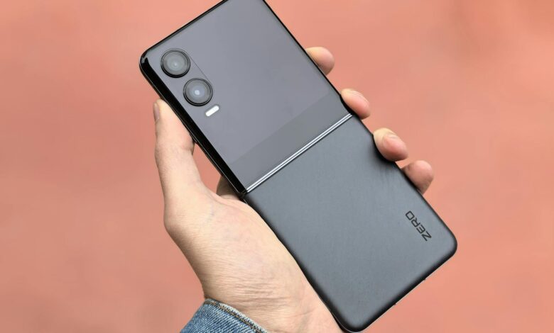Close-up of a hand holding a modern black flip smartphone, ideal for tech and lifestyle concepts.