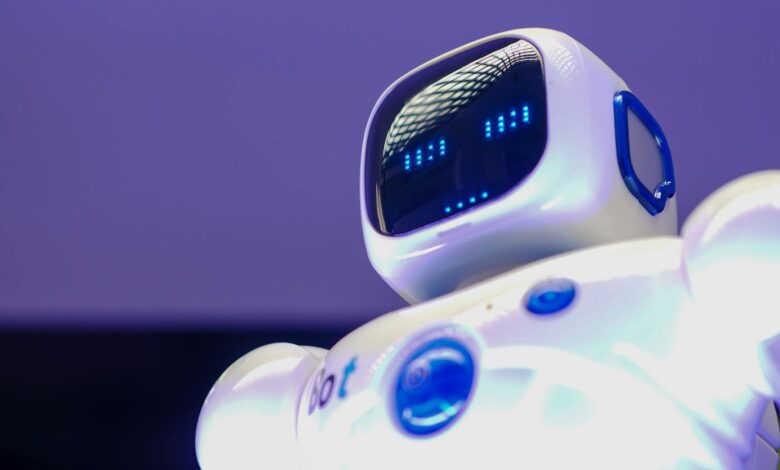 A modern humanoid robot with digital face and luminescent screen, symbolizing innovation in technology.