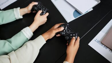 Two people playing video games with controllers, highlighting teamwork and gaming experience.