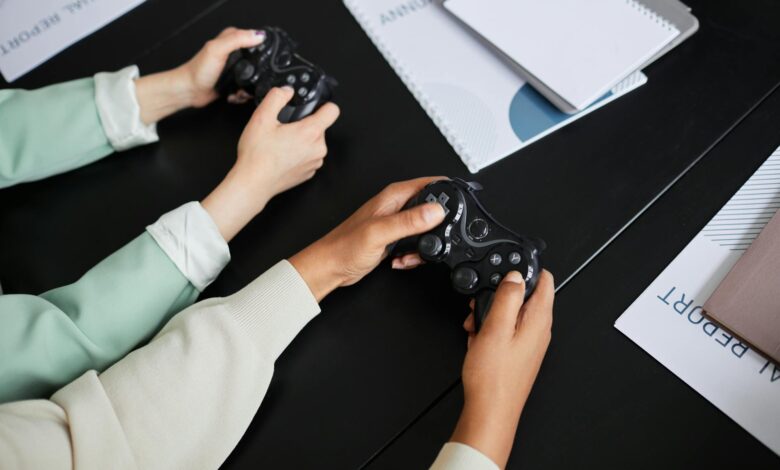 Two people playing video games with controllers, highlighting teamwork and gaming experience.