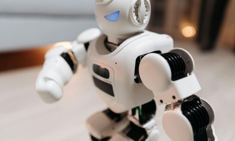 Close-up of a futuristic toy robot with blue eyes, showcasing modern technology indoors.