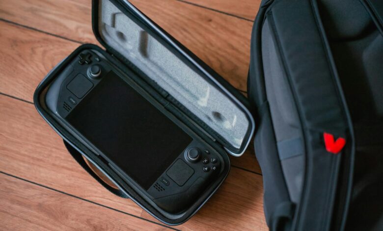 A close-up shot of a gaming console in its case next to a backpack on a wooden floor.