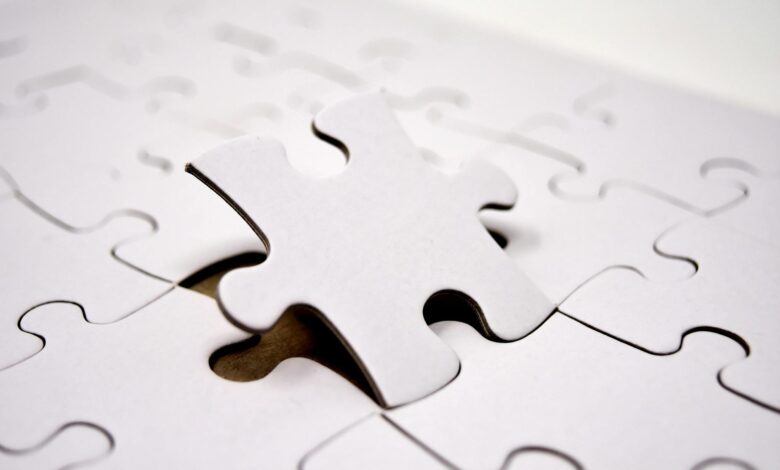 A single white jigsaw puzzle piece fitting into place. Ideal for concepts of problem-solving and solutions.