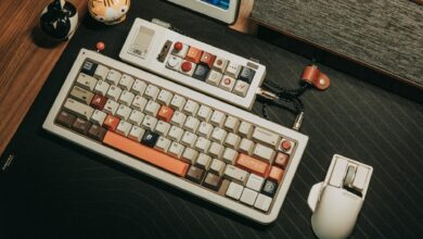 Custom mechanical keyboard and mouse setup on a wooden desk with a retro aesthetic.