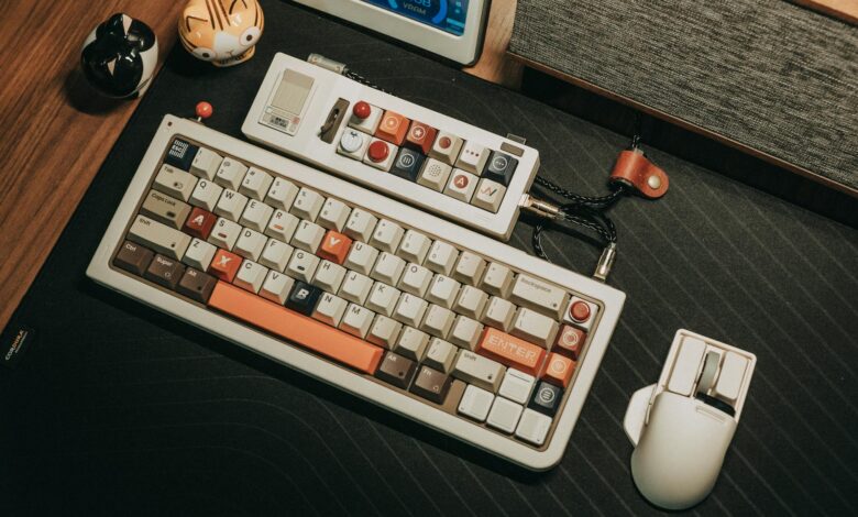 Custom mechanical keyboard and mouse setup on a wooden desk with a retro aesthetic.
