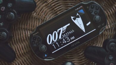 PS Vita showing 007 theme surrounded by PlayStation controllers on a wicker basket.