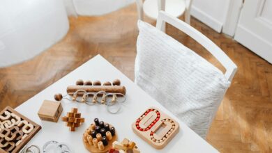 A collection of wooden puzzle toys arranged on a modern table in an indoor setting, perfect for encouraging intellectual play.