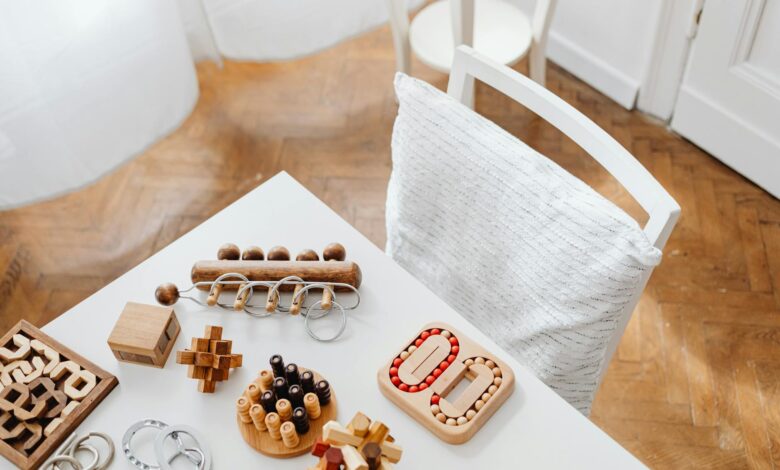 A collection of wooden puzzle toys arranged on a modern table in an indoor setting, perfect for encouraging intellectual play.