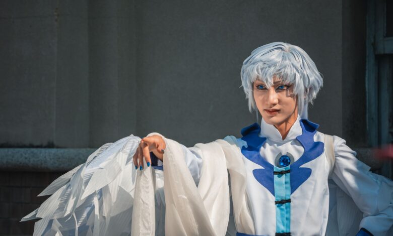 Stunning cosplay portrait with elaborate white and blue costume, showcasing expressive pose and detailed design.