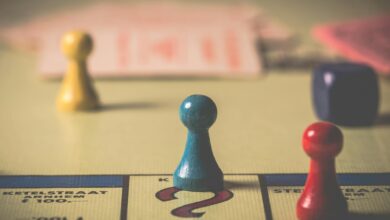 Close-up of a classic board game with vibrant tokens and dice on a playing board.