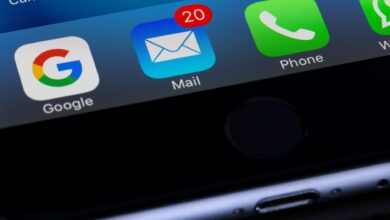 A close-up photo of a smartphone displaying popular apps like Google and Mail.