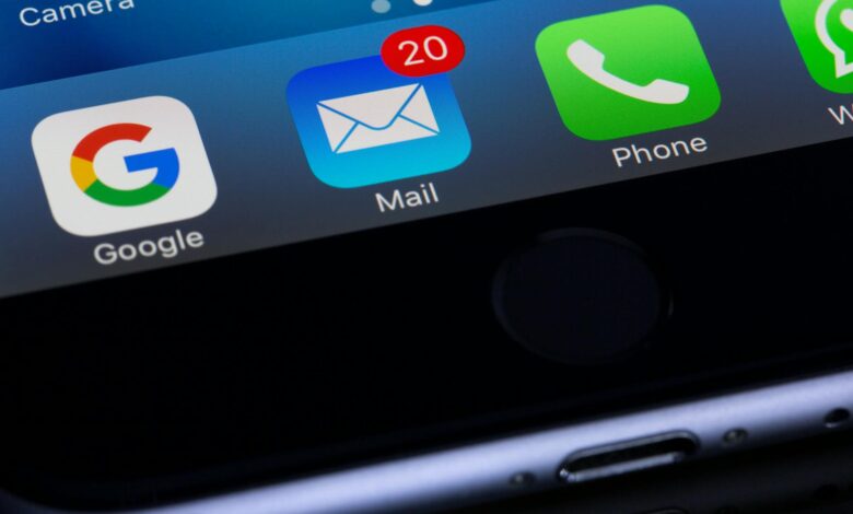 A close-up photo of a smartphone displaying popular apps like Google and Mail.