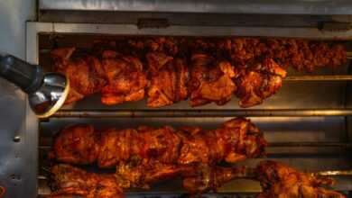 Mouth-watering rotisserie chickens cooking at a street food stall in Ciudad de México, perfect for cuisine lovers.