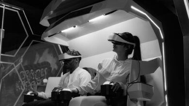 Immersive virtual reality gaming session with players wearing VR headsets, captured in black and white.