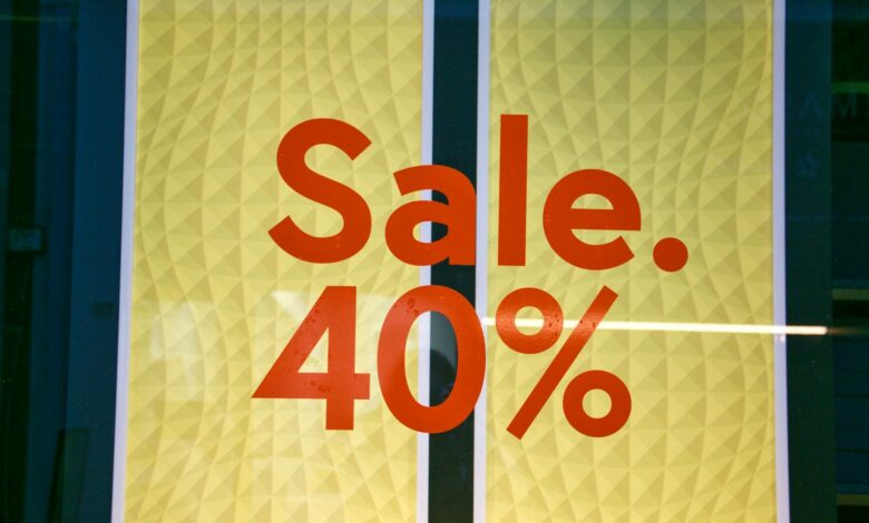 Bright retail sale sign showing 40 percent discount on yellow background.