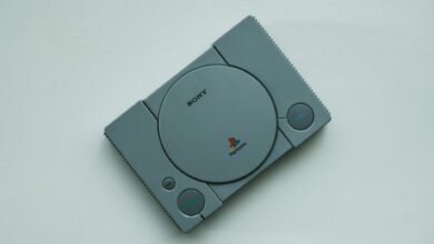 Close-up of a vintage Sony PlayStation console on a white background, highlighting retro gaming vibes.