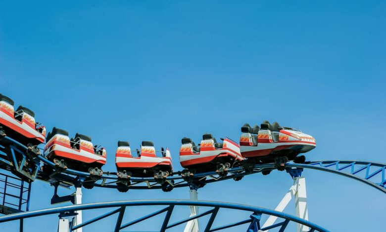 Exciting roller coaster ride with vibrant colors against a clear blue sky.