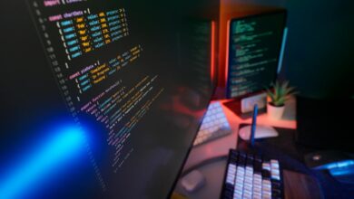 A vibrant workspace featuring colorful code on computer monitors, ideal for developers.