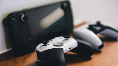 Stylish setup of gaming controllers and console on wooden surface.